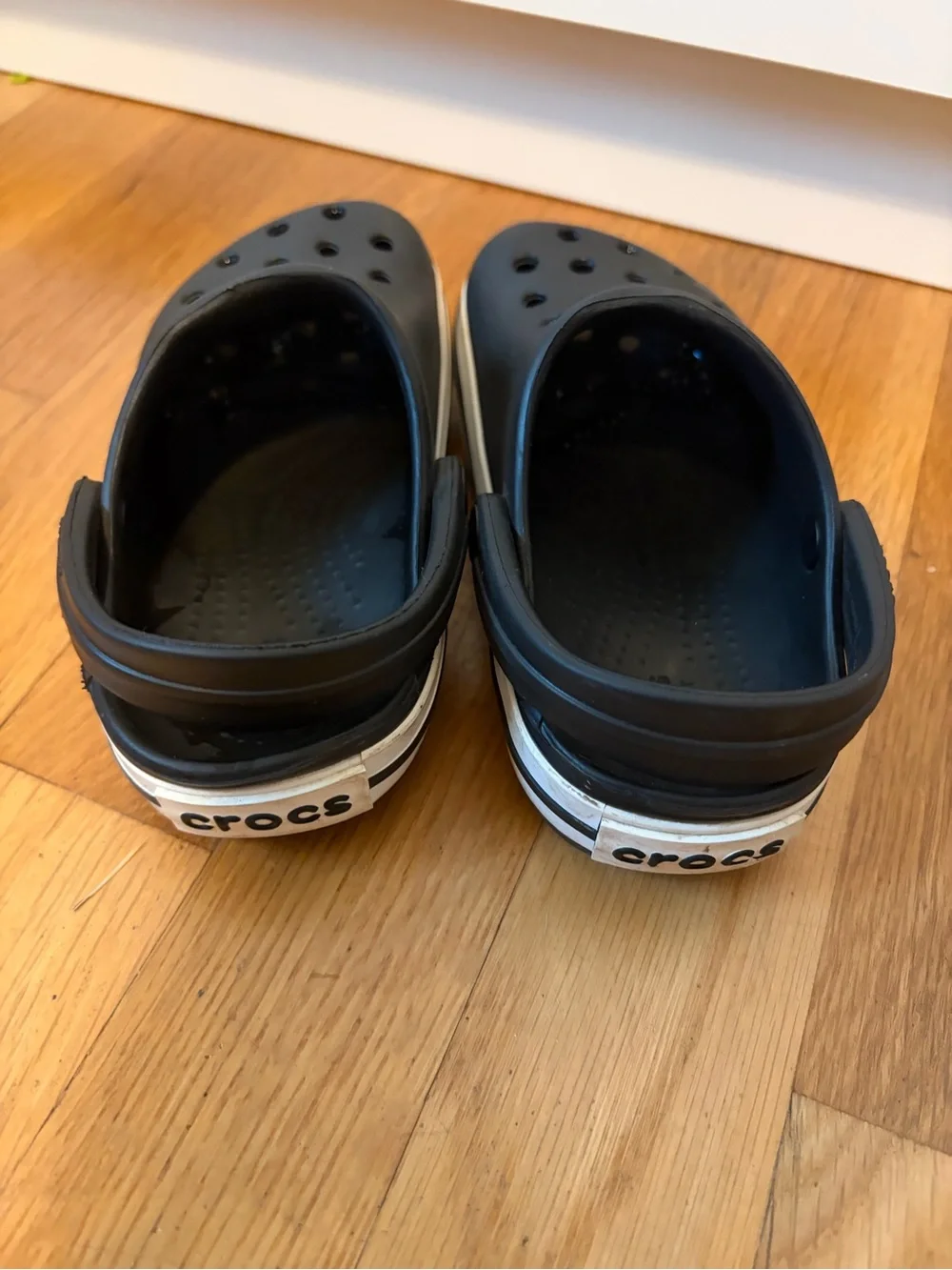 Kid’s black Croc slip on shoe with white band size 8